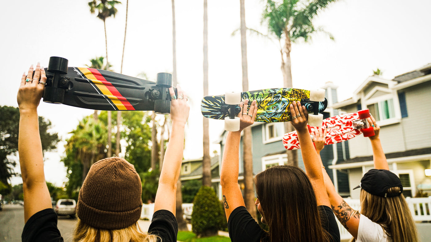 People Holding a Skateboard Banner